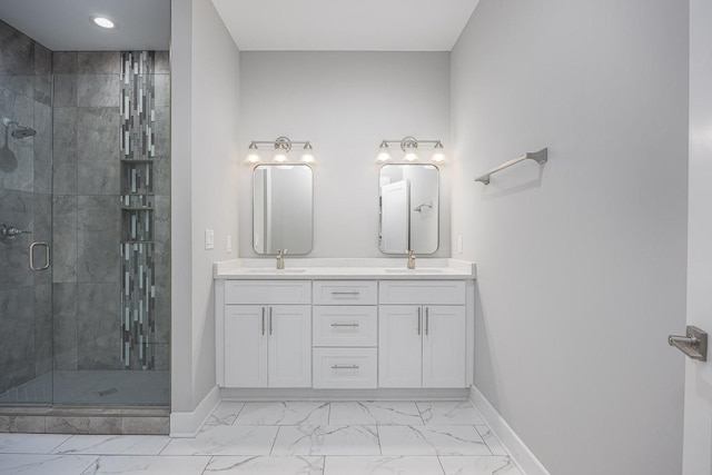 bathroom featuring a shower with shower door and vanity