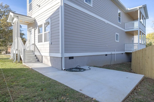 view of home's exterior with a yard and a patio area