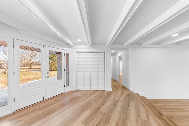 interior space featuring light hardwood / wood-style flooring and beamed ceiling