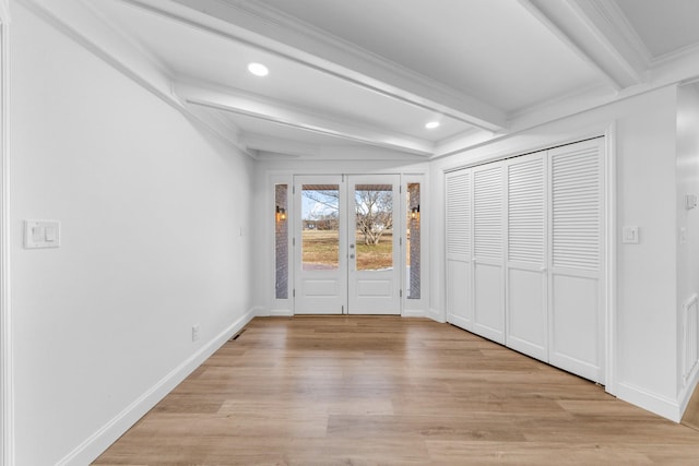 unfurnished bedroom with light hardwood / wood-style floors, crown molding, and beam ceiling