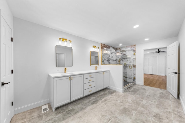 bathroom featuring ceiling fan, vanity, and a shower with door