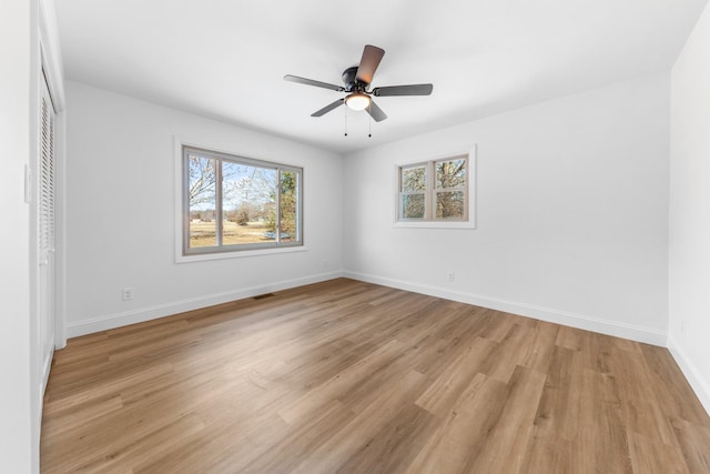 unfurnished bedroom featuring ceiling fan, light wood-type flooring, and a closet