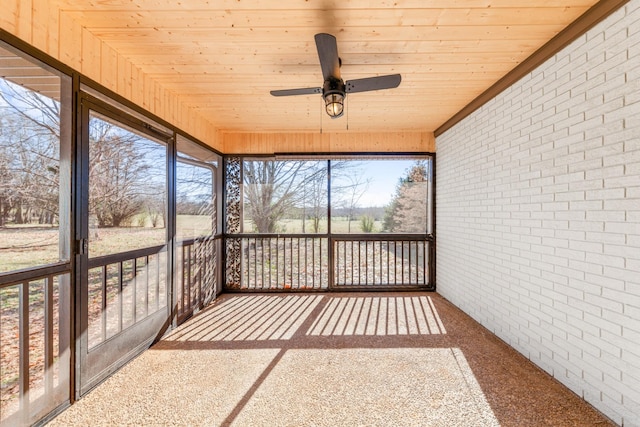 unfurnished sunroom featuring ceiling fan and wood ceiling