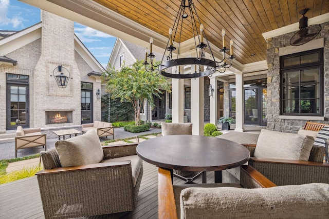 exterior space with a wooden deck and an outdoor living space with a fireplace