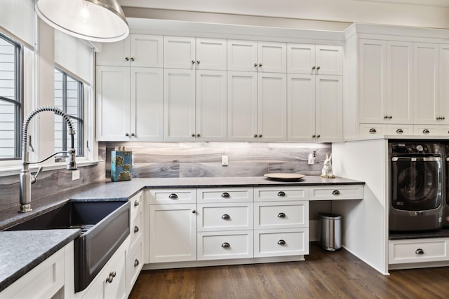 kitchen featuring sink, stainless steel oven, tasteful backsplash, and white cabinetry