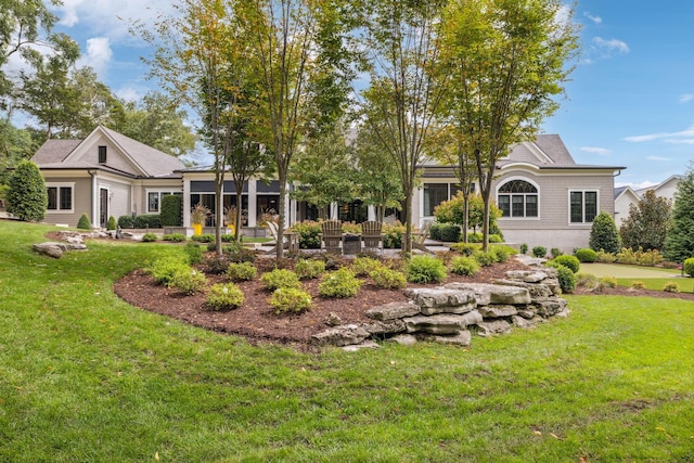 rear view of property with a yard