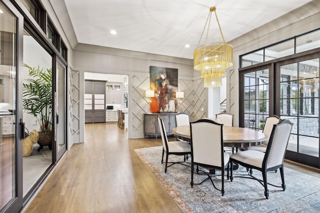 dining space with an inviting chandelier and hardwood / wood-style floors