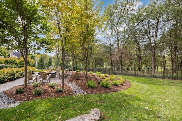 view of yard featuring a patio and an outdoor fire pit