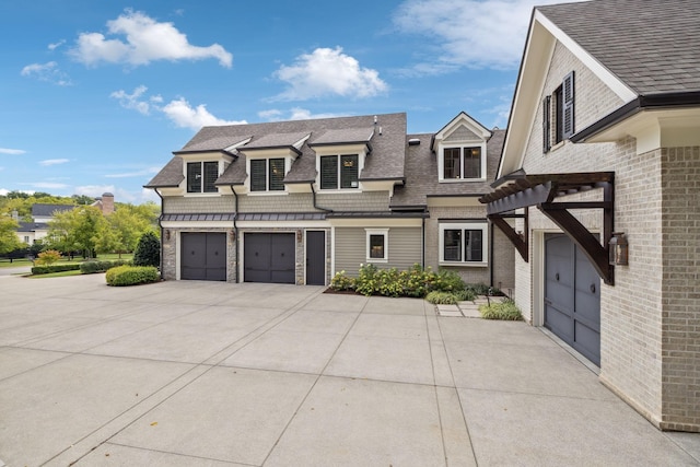 view of front of home with a pergola and a garage