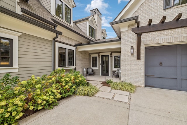 view of exterior entry with a garage