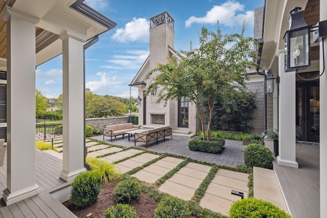 view of patio with an outdoor living space with a fireplace