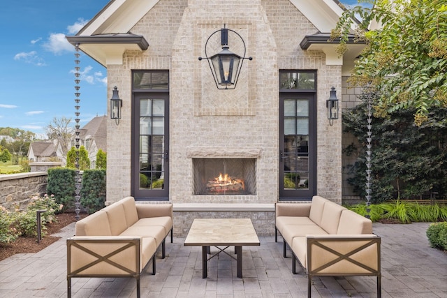 view of patio / terrace featuring an outdoor living space with a fireplace