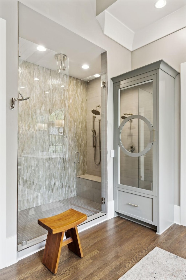 bathroom featuring wood-type flooring and walk in shower