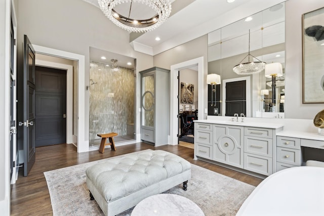 bathroom featuring hardwood / wood-style flooring, an inviting chandelier, and vanity