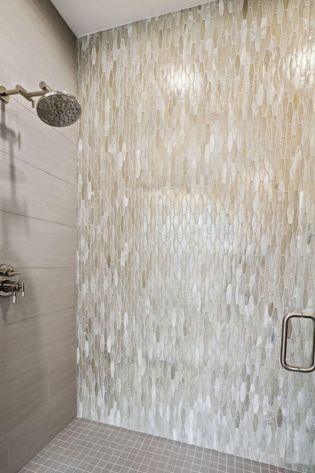 bathroom with a shower with door