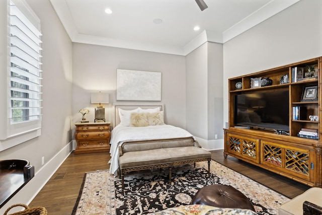 bedroom featuring dark hardwood / wood-style flooring, ceiling fan, and crown molding