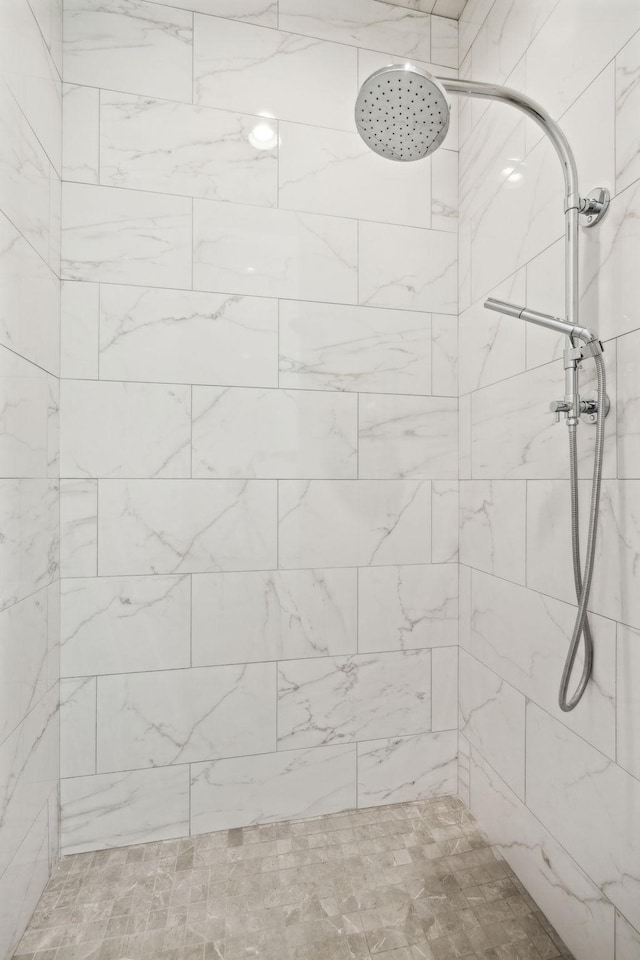 bathroom with tiled shower