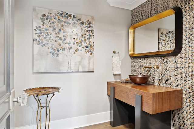 bathroom featuring tasteful backsplash and vanity