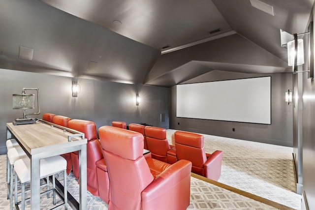 home theater with vaulted ceiling and carpet