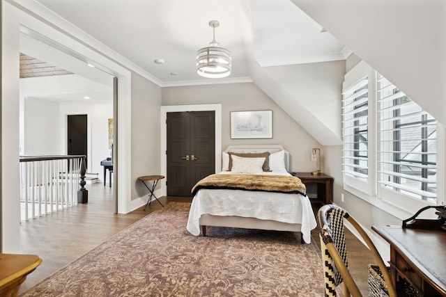 bedroom featuring a notable chandelier, crown molding, multiple windows, and hardwood / wood-style flooring