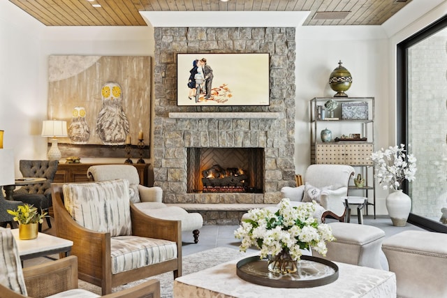 living area with a fireplace and wooden ceiling