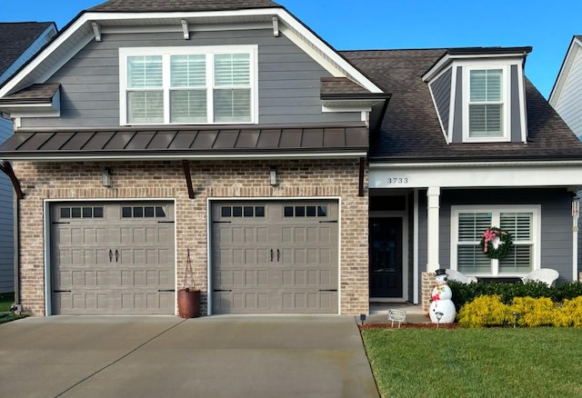 view of front of house featuring a garage and a front lawn