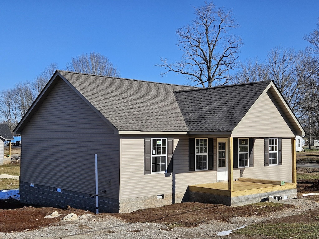 view of side of property with covered porch