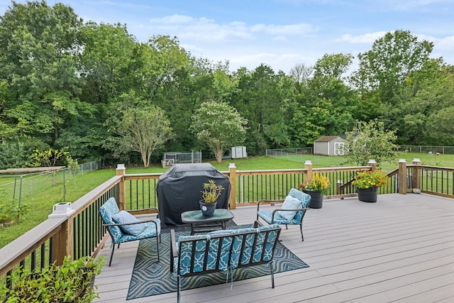 wooden terrace with a yard, a grill, a storage unit, and outdoor lounge area