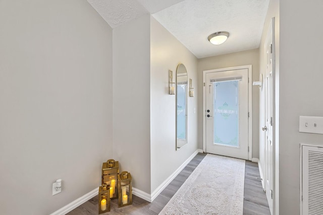 entryway featuring a textured ceiling and wood-type flooring