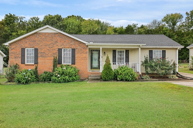 single story home with a front yard and covered porch