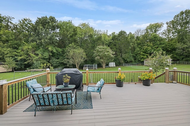 deck with a yard, grilling area, and a storage shed