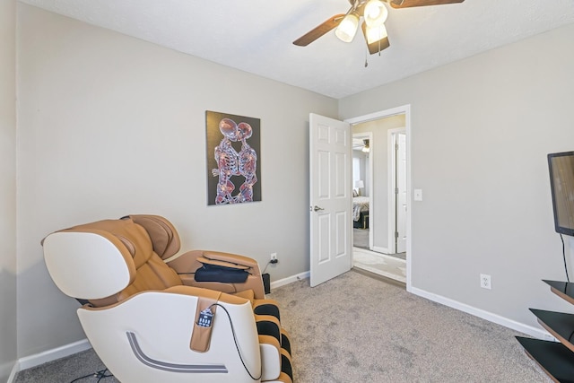 sitting room with ceiling fan and light carpet