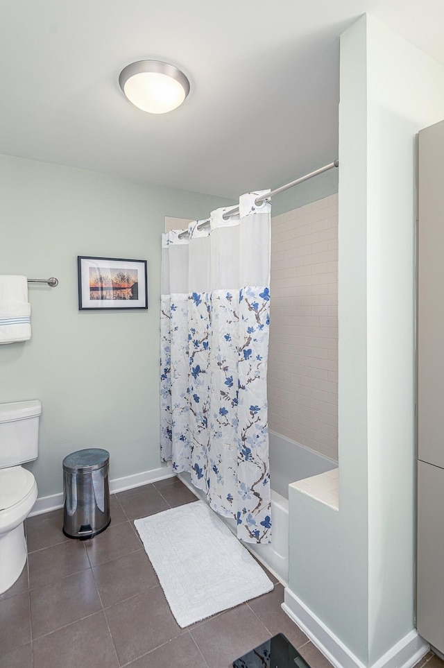 bathroom with toilet, tile patterned flooring, and shower / tub combo with curtain