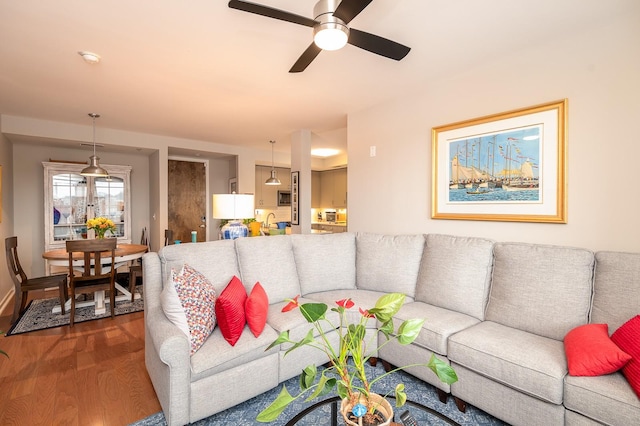 living room featuring sink, ceiling fan, and hardwood / wood-style floors