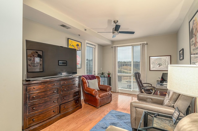 living room with light wood-type flooring and ceiling fan