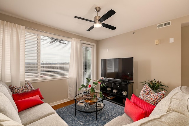 living room featuring hardwood / wood-style flooring and ceiling fan