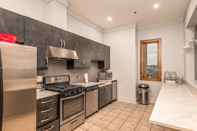 kitchen with stainless steel appliances, light tile patterned floors, dark brown cabinetry, sink, and tasteful backsplash