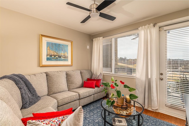 living room featuring ceiling fan and hardwood / wood-style flooring