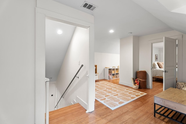 interior space featuring lofted ceiling and hardwood / wood-style floors