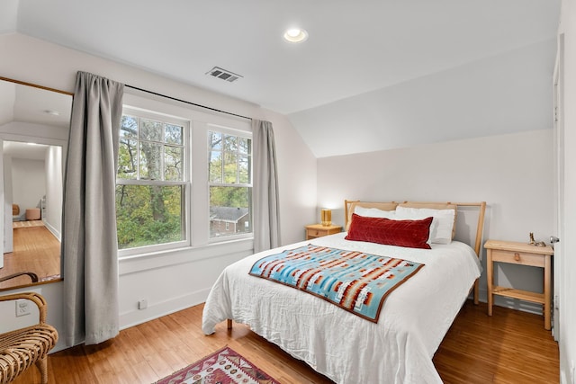 bedroom featuring vaulted ceiling and wood-type flooring