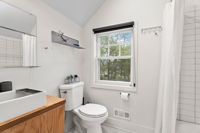 full bathroom featuring shower / tub combo, lofted ceiling, vanity, and toilet