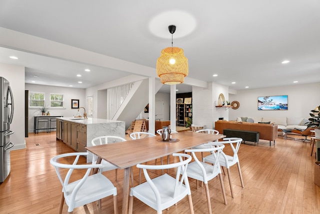 dining room featuring sink and light wood-type flooring