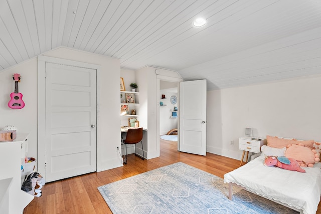 bedroom featuring lofted ceiling, light wood-type flooring, and wood ceiling