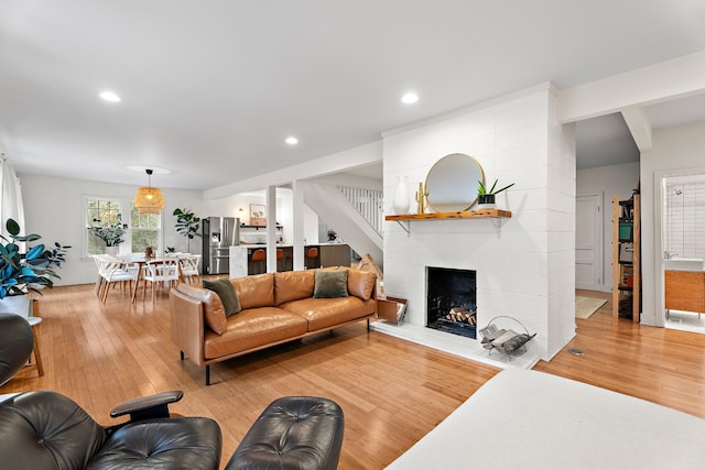 living room featuring hardwood / wood-style floors and a large fireplace