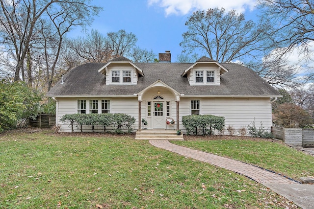 cape cod house featuring a front yard