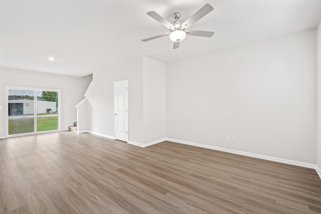 unfurnished living room with ceiling fan and wood-type flooring