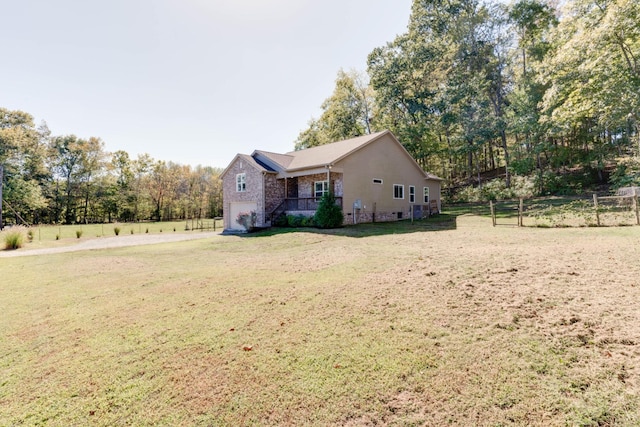 view of side of property featuring a porch and a lawn