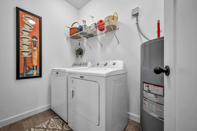 washroom with electric water heater, washer and clothes dryer, and dark wood-type flooring