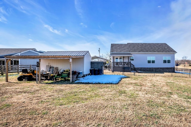 rear view of property featuring a yard