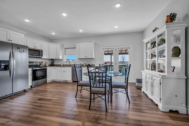 kitchen with stainless steel appliances, french doors, dark hardwood / wood-style flooring, white cabinets, and sink